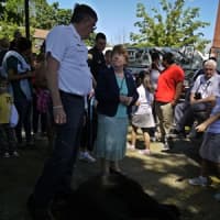 <p>Danbury residents watch as the 275-pound bear was brought down from the tree mid Tuesday morning.</p>