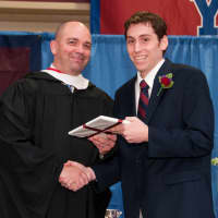<p> Nathanael Alexander of Katonah, who received both the David Muntner Theatre Tech Award and the Citizenship Award, is congratulated by Upper School Head Phil Lazzaro at The Harvey School commencement June 6</p>