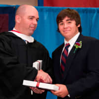 <p>Guillermo Leon of Katonah receives the Science Prize at The Harvey School commencement June 6 from Upper School Head Phil Lazzaro.</p>