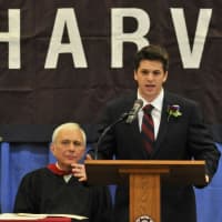 <p>Jesse Silbert addresses the gathering at commencement as Headmaster Barry Fenstermacher listens.</p>