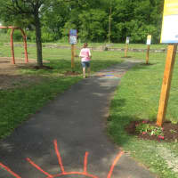 <p>A kid begins to venture down the new Born Learning Trail at Rogers Park in Danbury. </p>