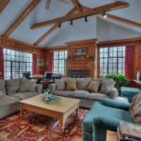 <p>The family room at Ox Ridge Farm has cathedral ceilings and exposed beams</p>