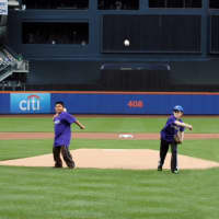 <p>Ryan Heinzerling, a Starlight supporter from Greenwich, Conn., throws the first pitch before the Mets game with Ernesto Martinez (left), a 9-year-old boy from Yonkers fighting Acute Lymphoblastic Leukemia.</p>
