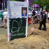 <p>A sign in memory of Dylan Hockley stands in the front of the playground.</p>