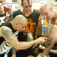<p>Danny from Dobbs Ferry, right, shows off a Misfits skull logo tattoo at the Clockwork Records signing.</p>