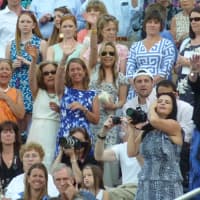 <p>Parents, family and friends wave at the graduates during the processional.</p>