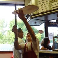 <p>Anthony DiFabio  son of master pizza maker Bruno DiFabio, owner of Wilton&#x27;s Pinochhio Pizza  spins a pizza dough Tuesday during the restaurant&#x27;s A Slice for the Cure event.</p>