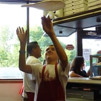 <p>Anthony DiFabio, future owner of Wilton&#x27;s Pinocchio Pizza, spins a pizza dough into the air during Tuesday&#x27;s A Slice for the Cure event. Anthony, 14, is son of master pizza maker and restaurant owner Bruno DiFabio.</p>
