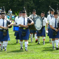 <p>A bag pipe band performs at the Round Hill Highland Games at Cranbury Park in Norwalk on Saturday.</p>