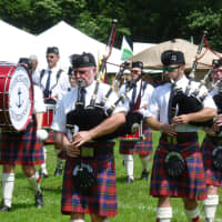 <p>A bag pipe band performs Scottish songs Saturday at the annual Round Hill Highland Games at Cranbury Park in Norwalk.</p>
