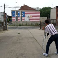 <p>Robert Carley, of Darien, takes a picture of a patriotic display. His exhibit, Flags Across America, is up at the Bruce Museum in Greenwich, Conn.</p>