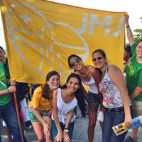 <p>Fairfield University students Jennifer Salit (front row left, yellow tee shirt) and Jessica Estrada (far right, green tee shirt) celebrating Magis 2013 and World Youth Day in Brazil this month.</p>