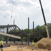 <p>Ironworkers from United Steel guide a signed steel beam to its final setting in the new Westport Weston Family Y facility. The beam was the last major piece of steel that needed to be installed.</p>