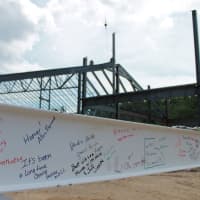 <p>A 20-foot steel beam, signed by Y officials, members and supporters, was installed Wednesday. </p>