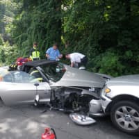 <p>Westport firefighters and EMS work to get an injured driver out of a damaged Corvette Friday afternoon following a five-car pileup on Riverside Avenue.</p>