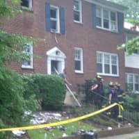 <p>Firefighters clear debris from the apartment on Underhill Avenue.</p>