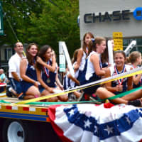 <p>The 10-11 girls&#x27; softball team is all smiles during Monday&#x27;s Little League parade in downtown Westport.</p>