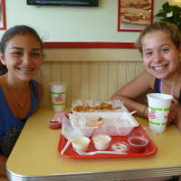 <p>Hannah Glehan, right, and Gianna Cotignola try the new Planet Wings in Ardsley.</p>