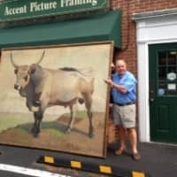 <p>Geary Gallery owner Tom Geary stands with his latest big project, a framed 7 x 9-foot oil painting.</p>
