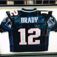 <p>A framed jersey of New England quarterback Tom Brady is one of the unique pieces created by Geary Gallery.</p>