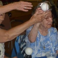 <p>Sister LaChance shows off the baseball signed and sent to her by New York Yankees great Mariano Rivera for her birthday.</p>