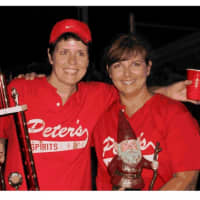 <p>Player/manager Kathleen O&#x27;Connell, left, and MVP Heidi Keeney celebrate after Peter&#x27;s Spirits won the Weston Women&#x27;s Softball League championship.</p>