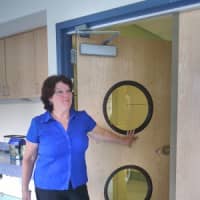 <p>Trinity Nursery School Director Meg Reilly showed off the new doors which include a window for the children at the bottom so they can look out into the hallway. </p>
