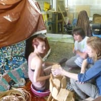 <p>Kelly Knowles, left, and Owen Cahill work on art exhibits for the &quot;Take Me To The river Festival&quot;</p>