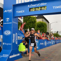 <p>Mike Christie crosses the finish line in winning his age group at the Ironman in Coeur d&#x27;Alene in June.</p>