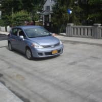 <p>City Council member Richard Filippi drives the first car over the newly re-opened Central Avenue bridge.</p>