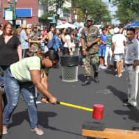 <p>Jene&#x27;via Smith, longtime New Rochelle resident, tries her hand at the high striker game.</p>