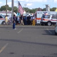 <p>An injured child is put into an ambulance Sunday at the Norwalk Oyster Festival. Most of the children injured in a ride malfunction were treated at the scene. </p>