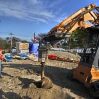 <p>Travis Rekos, the brother of Sandy Hook victim Jessica, helped to start digging the new playground at Fairfield&#x27;s Penfield Beach Friday morning. </p>