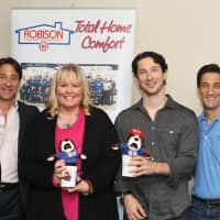 <p>David Singer, co-President of Robison Oil, left, stands with  Dr. Kathy Reilly Fallon of Heavenly Productions Foundation, Jonny Hirsch and Daniel Singer, Co-President of Robison Oil.</p>