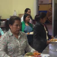 <p>Patrons line up to receive lunch at Caritas of Port Chester.</p>