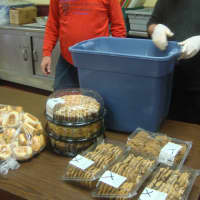 <p>Caritas of Port Chester volunteers unpack donations of bread and cookies.</p>