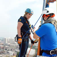 <p>Wilton Police Officer Diane MacLean prepares to scale down a 16-story building in Stamford during the &quot;Over the Edge&quot; Special Olympics fundraiser.</p>