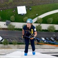 <p>Wilton Police Officer Diane MacLean makes her descent down a 16-story building in Stamford.</p>