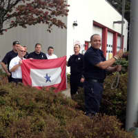 <p>Westport Firefighter Pete Nichio (at flagpole) recently returned home from a year long military deployment in Afghanistan. </p>