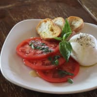 <p>Maple-Brook Farms burrata, made from fresh cow&#x27;s milk and served with grilled bread and fresh tomatoes ($12)</p>