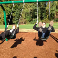 <p>Mclivenny-Moore and Ball test out the new swings. </p>