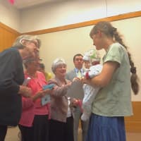 <p>Members of the Daughters of Revolution, League of Women Voters and the National Ladies Auxiliary of the Jewish War Veterans handed the new citizens pamphlets and small American flags after they accepted their certificates.</p>