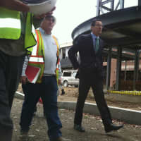 <p>Gov. Dannel P. Malloy walks with construction workers in front of J. M. Wright Technical High School Thursday. A ceremonial groundbreaking was held at the Stamford school that will reopen next year.</p>