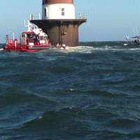 <p>Marine Units from the Norwalk Fire and Police Departments respond to help a boat taking on water near Peck&#x27;s Ledge Lighthouse.</p>