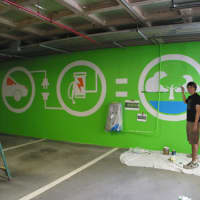 <p>Conor Heelan painted a full-scale mural on the parking garage wall where the charging station is located. </p>