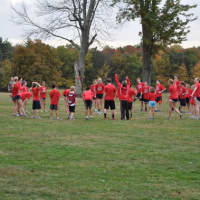 <p>Members of the New Canaan Running Club stretch prior to the race.</p>