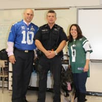 <p>(From left) Alexander High School Principal  Marc Biaocco, Greenburgh Police Det. Wayne Popovich and science teacher Julianna Puma with K-9 Officer Metro.</p>