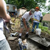 <p>Benjamin Emanuel (orange bandana) and ING volunteers work on 120 High Street, Veteran build, Yonkers. June 28, 2013
</p>
