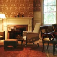 <p>In the living/sitting room. senior designer Dorothy Vivas selected wallcoverings and fabrics by Morris &amp; Co., an English company.</p>