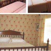 <p>A second guest room was wallpapered with Sandersons Garden Tulip and operable pinch-pleated draperies fashioned from matching fabric.</p>